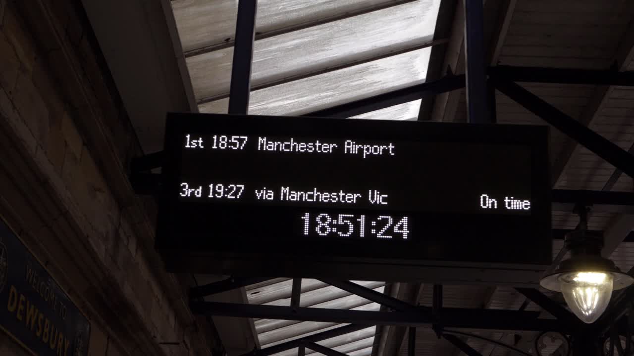 Timetable display in train station platform to Manchester
