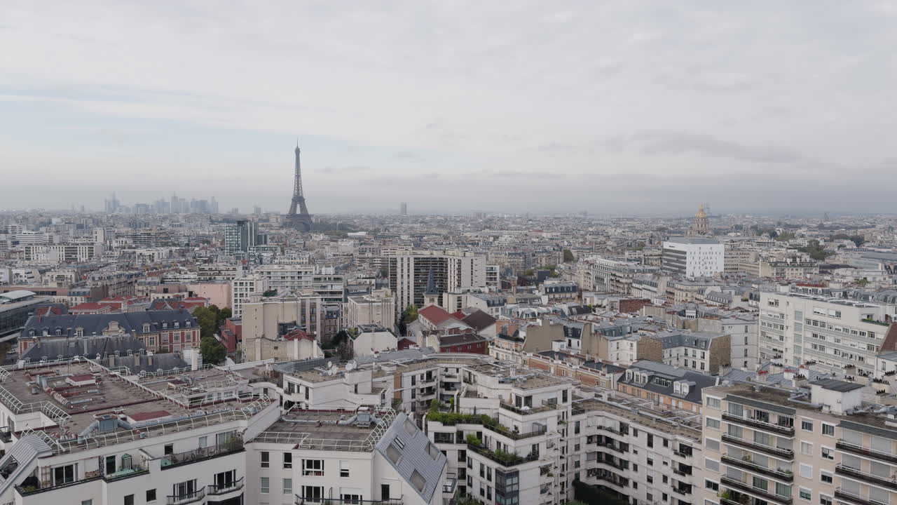 Wide static view of buildings in cloudy Paris, Eiffel Tower by horizon