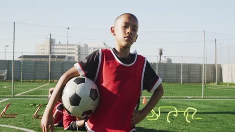african american soccer kid exercising in a sunny day
