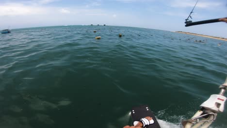 Spectacular-pov-shot-of-male-kite-surfer-surfing-over-fishing-nets-in-Pacific-Ocean-during-vacation-in-Asia