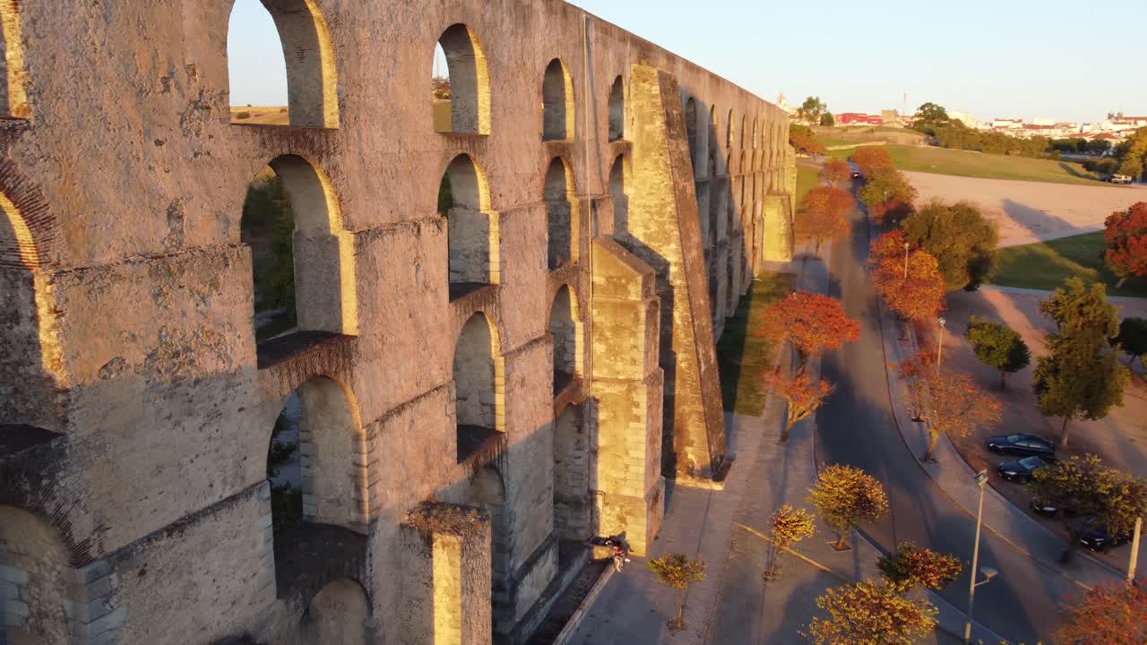 Drone shot flying near an aqueduct in Elvas, Portugal during sunset with a spin at the end