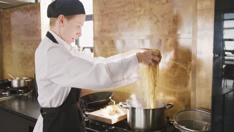 chef putting the pasta in boiling water