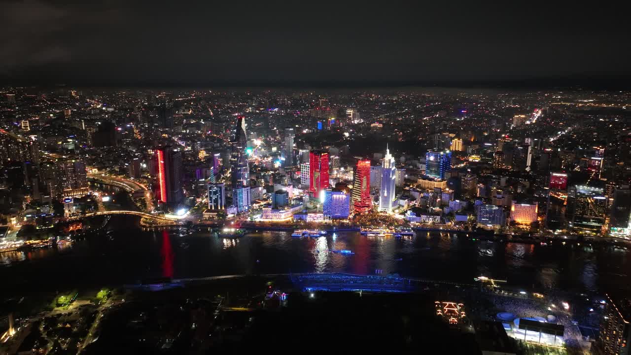 Downtown Ho Chi Minh City Skyline And Saigon River At Night in Vietnam. - aerial shot