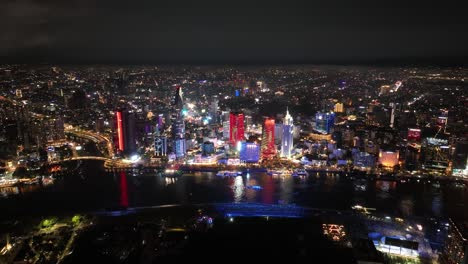 downtown ho chi minh city skyline and saigon river at night in vietnam. - aerial shot