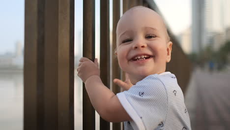 laughing boy at the age of 1 year dancing.