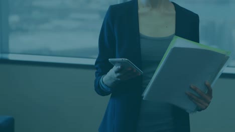 animation of financial statistics recording over businesswoman using smartphone