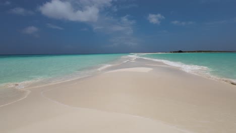 Seagull-bird-fly-on-sandbank,-sea-water-foam,-cayo-de-agua-island,-slow-motion