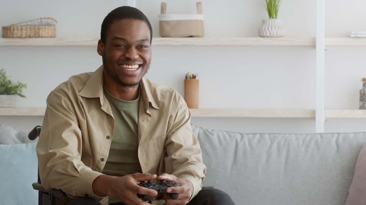 Happy Man Playing Video Games in Wheelchair