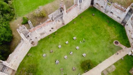 flying over framlingham castle wall at suffolk, england - aerial drone top down shot