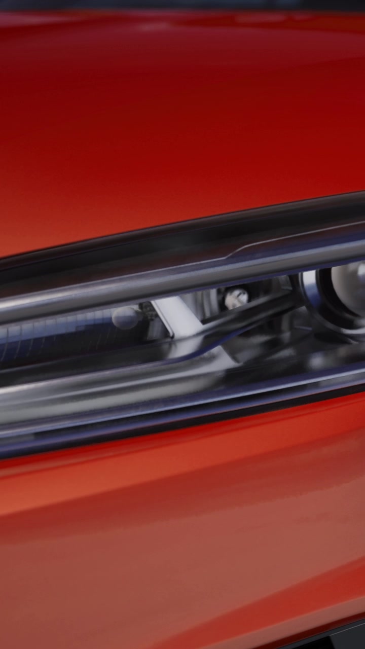 Close up of car headlight on orange vehicle
