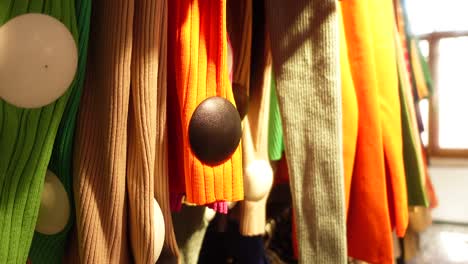 colorful knitted tops on hangers