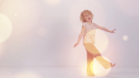 small girl dancing against a white wall