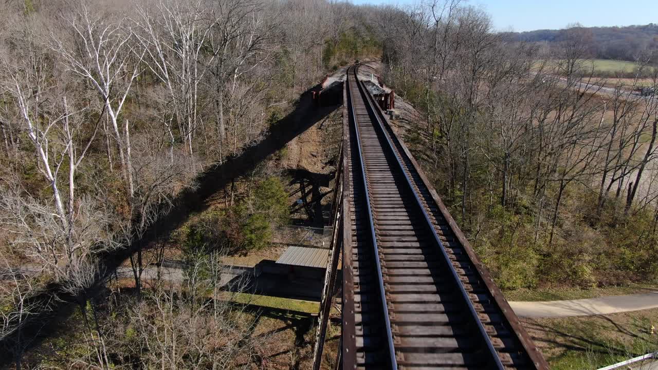 Aerial Shot Pushing Forward Along the Tracks of the Pope Lick Railroad Trestle in Louisville Kentucky on a Sunny Winter Day
