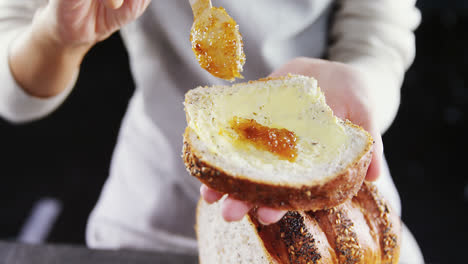 woman applying jam over multigrain bread slice 4k