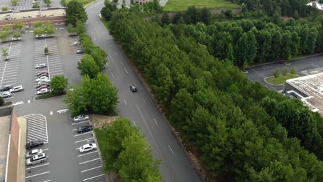 aerial ascending over trees. tracking car. city reveal