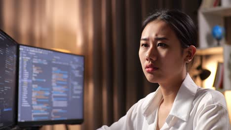 close up of asian woman programmer thinking about something and raising her index finger while creating software engineer developing app, program, video game on desktop computer at home