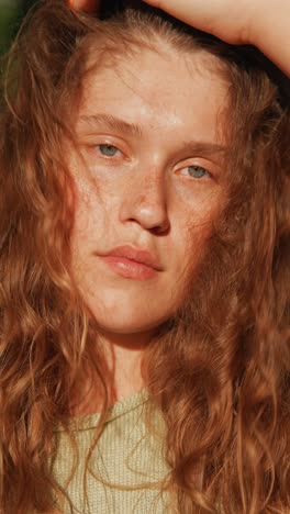 close-up portrait of a woman with red curly hair