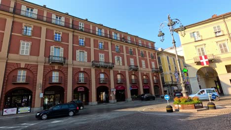 italian city square with buildings and cars