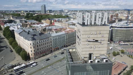 cinematic aerial footage of the main street in riga, latvia with the clock tower in the foreground, europe, drone