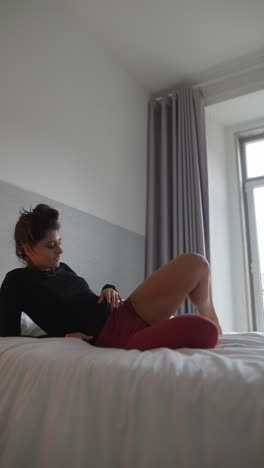 mujer haciendo yoga en una cama