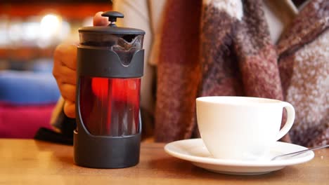 person preparing tea in a cafe.