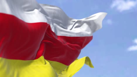 detail of the national flag of south ossetia waving in the wind on a clear day.