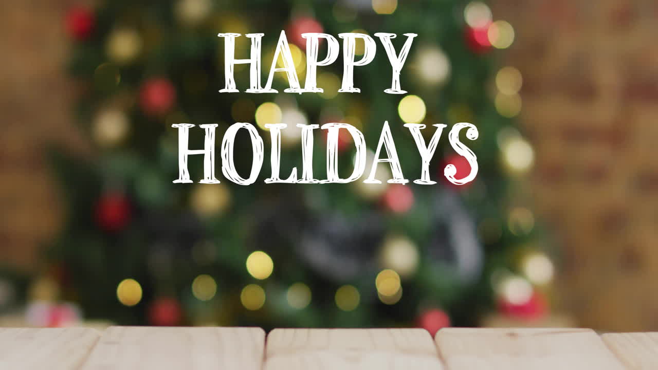 Happy Holidays text animation over blurred Christmas tree with lights