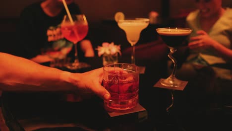 friends enjoying cocktails in a lively bar