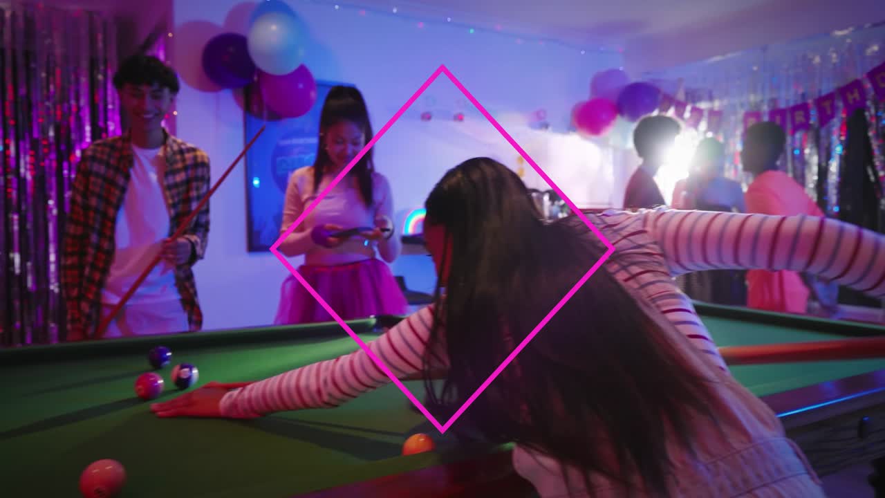Striped-shirt teen picking up cue and making pool shot for party, pink diamond overlay guiding aim