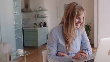 beautiful woman using laptop working at home browsing online reading social media messages on computer typing email enjoying digital communication