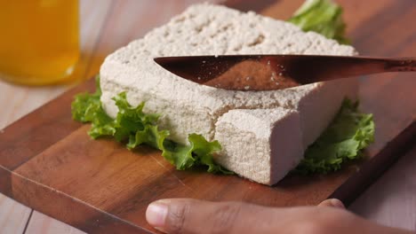 Top-view-of-hands-cutting-tofu-with-knife-,