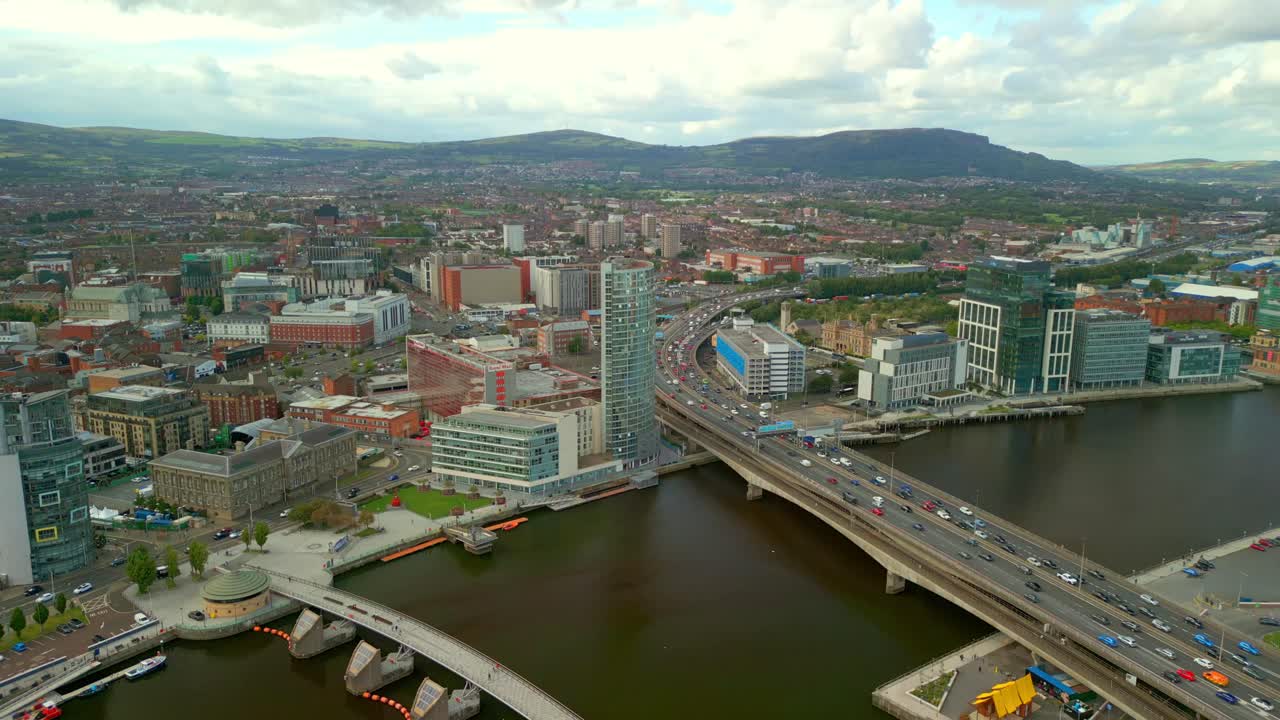 Wide reversing 4K aerial reveal video of Belfast City centre on a bright and sunny afternoon. Produced in 4K, 60FPS and with Rec709 color