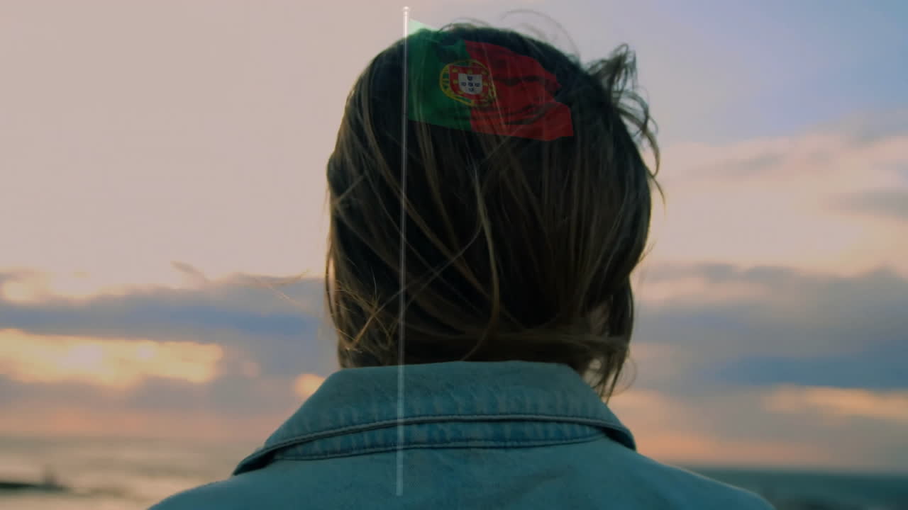 Gazing at ocean during sunset, woman with windblown hair in animation