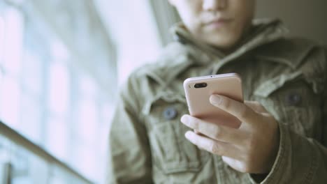 man using smartphone on metro station