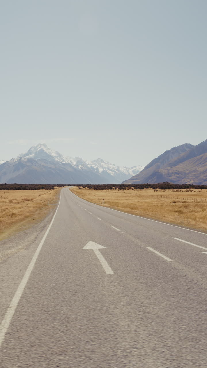 Empty Road Through Mountain Range in New Zealand