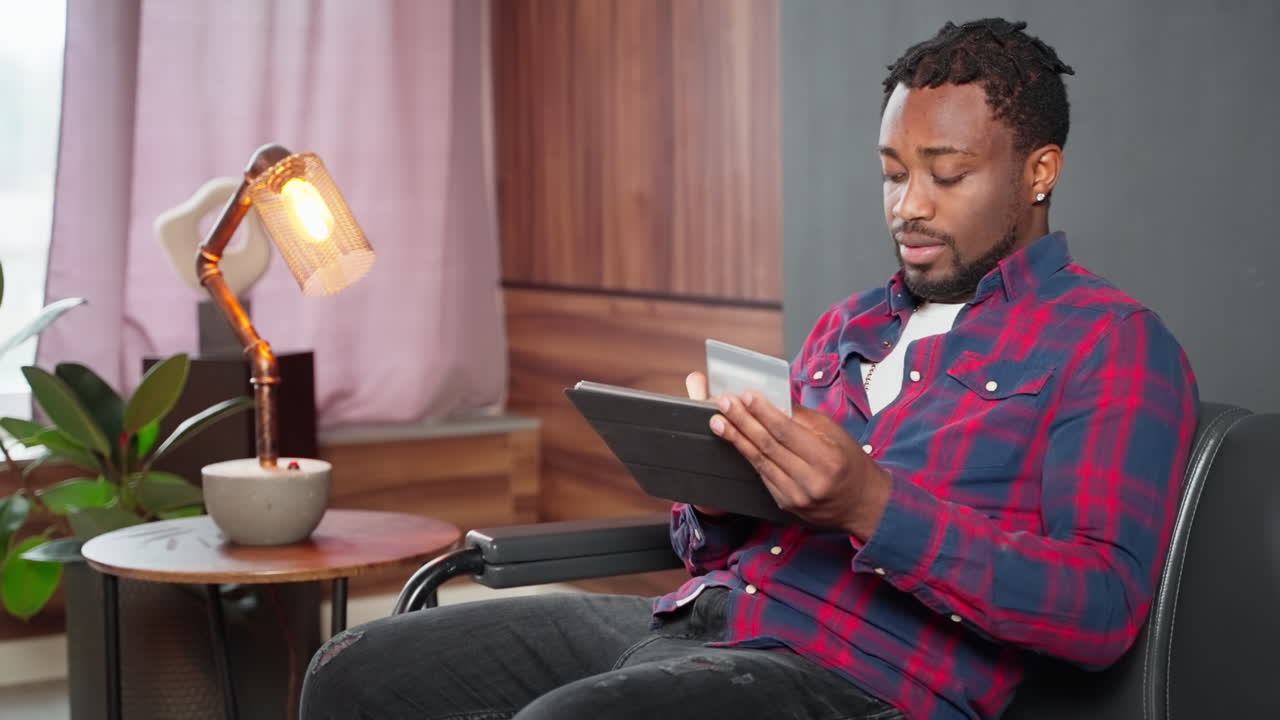 Man using a tablet and credit card