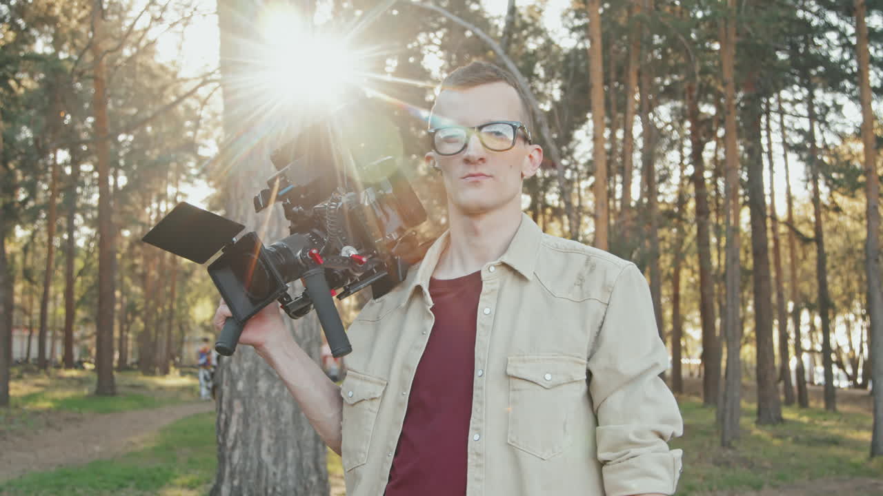 Portrait Of Male Operator With Video Camera Outdoors