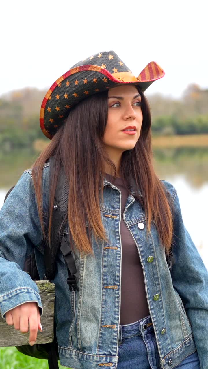 Woman in Cowboy Hat and Denim Jacket Outdoors