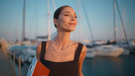 woman enjoying a sunset at the marina