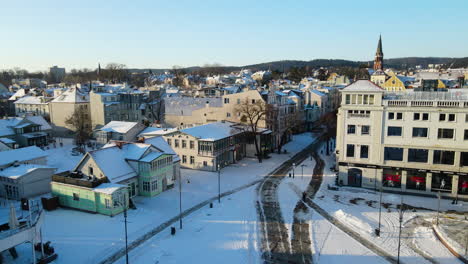 drone slow take of from the sopot city square revealing old ancient downtown architecture in winter cityscape