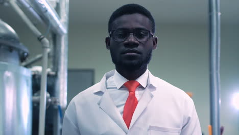 man in lab coat in industrial setting