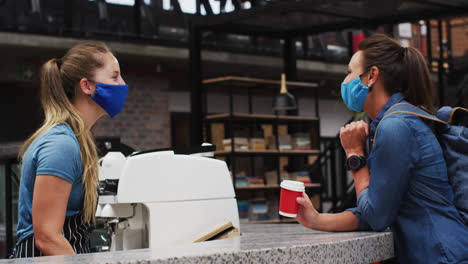 Mujer-Con-Mascarilla-Comprando-Una-Taza-De-Café-En-Una-Cafetería.