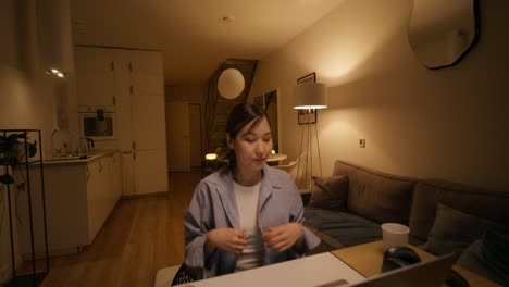 Woman working and getting dressed at home in the evening