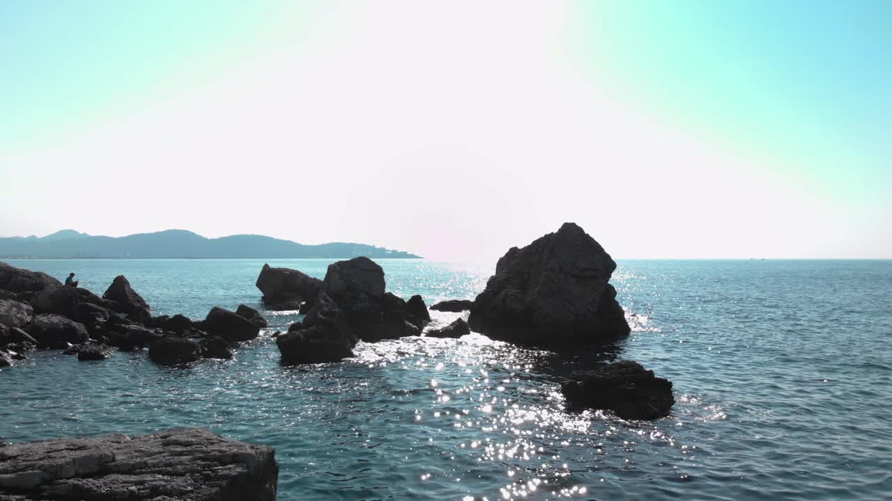 해변에 가까운 바다 바위의 낮은 드론 샷