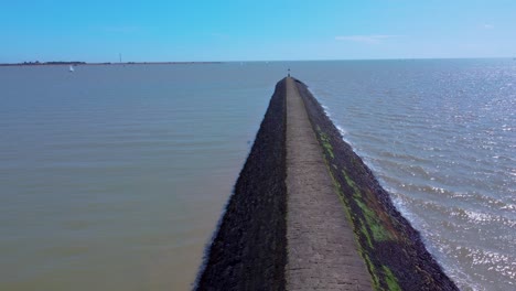 aerial seascape în harwich town in essex, england, drone revealing lighthouse with seagull flying over the ocean in a sunny bright day of summer sin uk