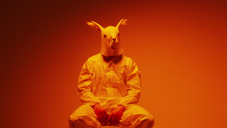 person in squirrel mask and protective suit