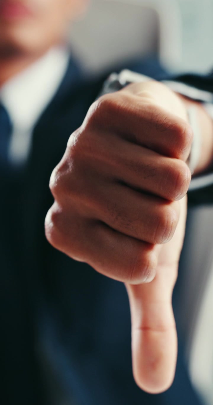 Businessman Giving a Thumbs Down Gesture