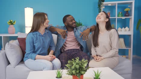 young people of different races chatting and happy at home.