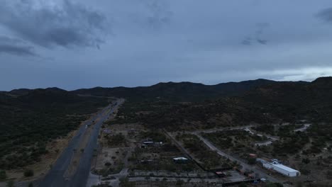 aerial-shot-of-drone-flying-over-road-or-highway-in-cloudy-day