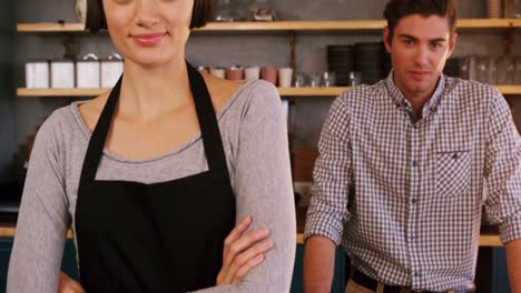 waitress smiling at a man standing behind